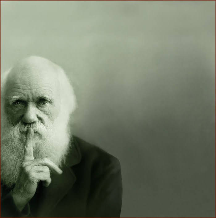 The meme features a black-and-white image of a person, likely a historical figure, with a stern expression and a finger to their lips, as if to say "shh" or "be quiet". The text overlayed on the image is likely a quote or phrase, but it's not specified in the original description.